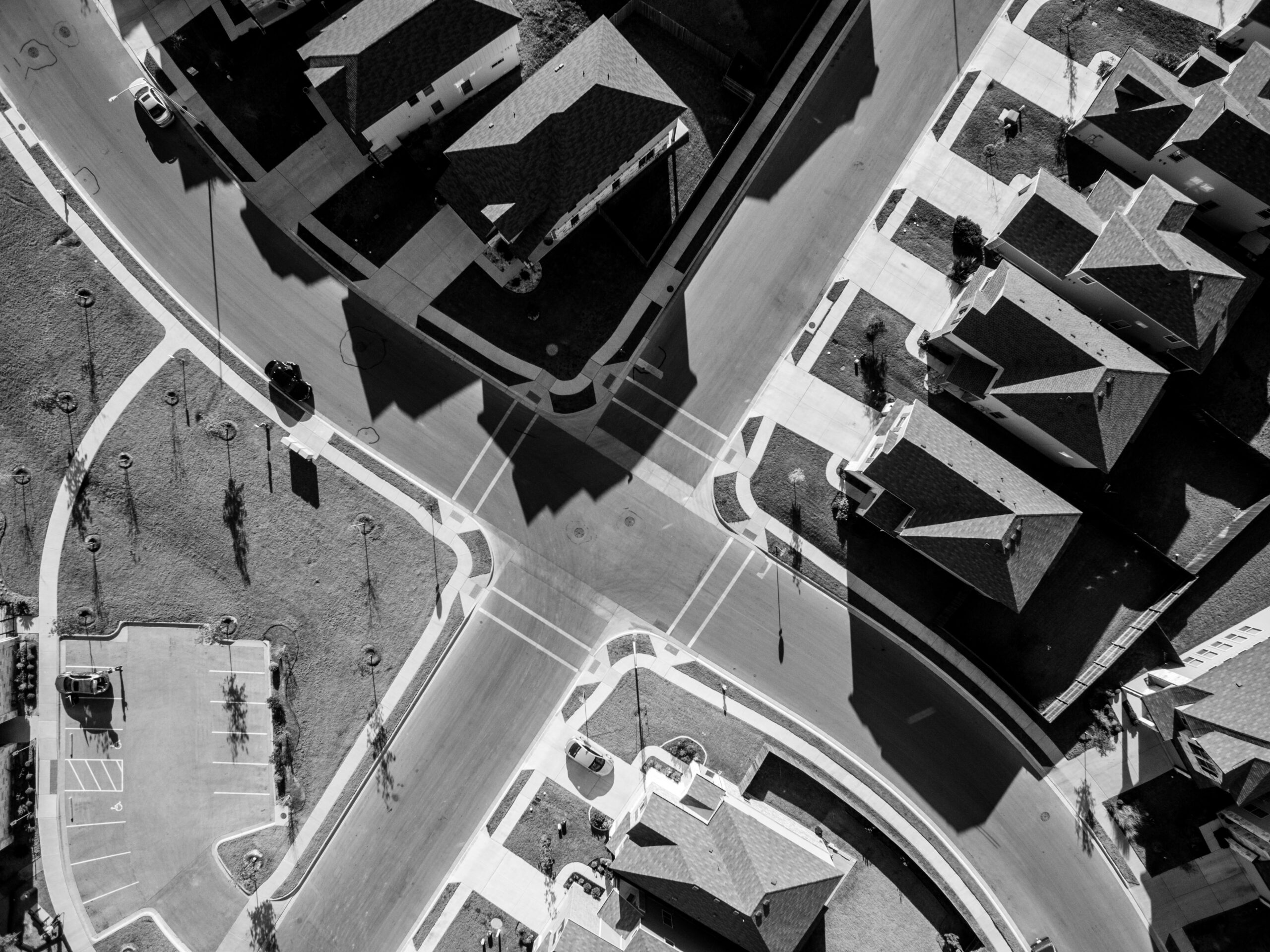 Looking Down from Aerial View Black and White Suburbs. Aerial: Looking Down Black and White Suburbs Rooftops Angles.