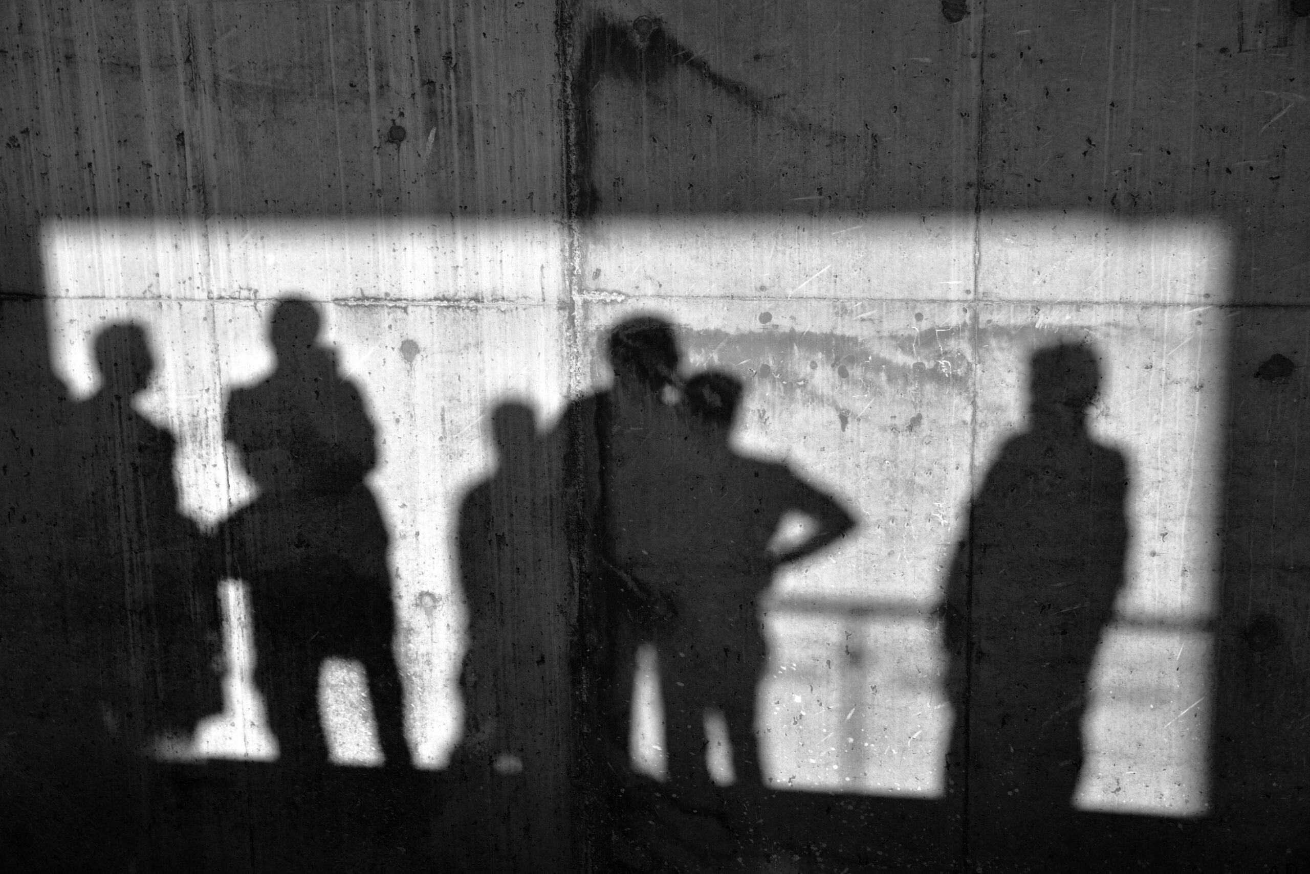 Men shadows on the concrete wall.